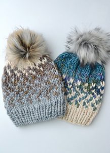 Two hand knit hats with pompoms