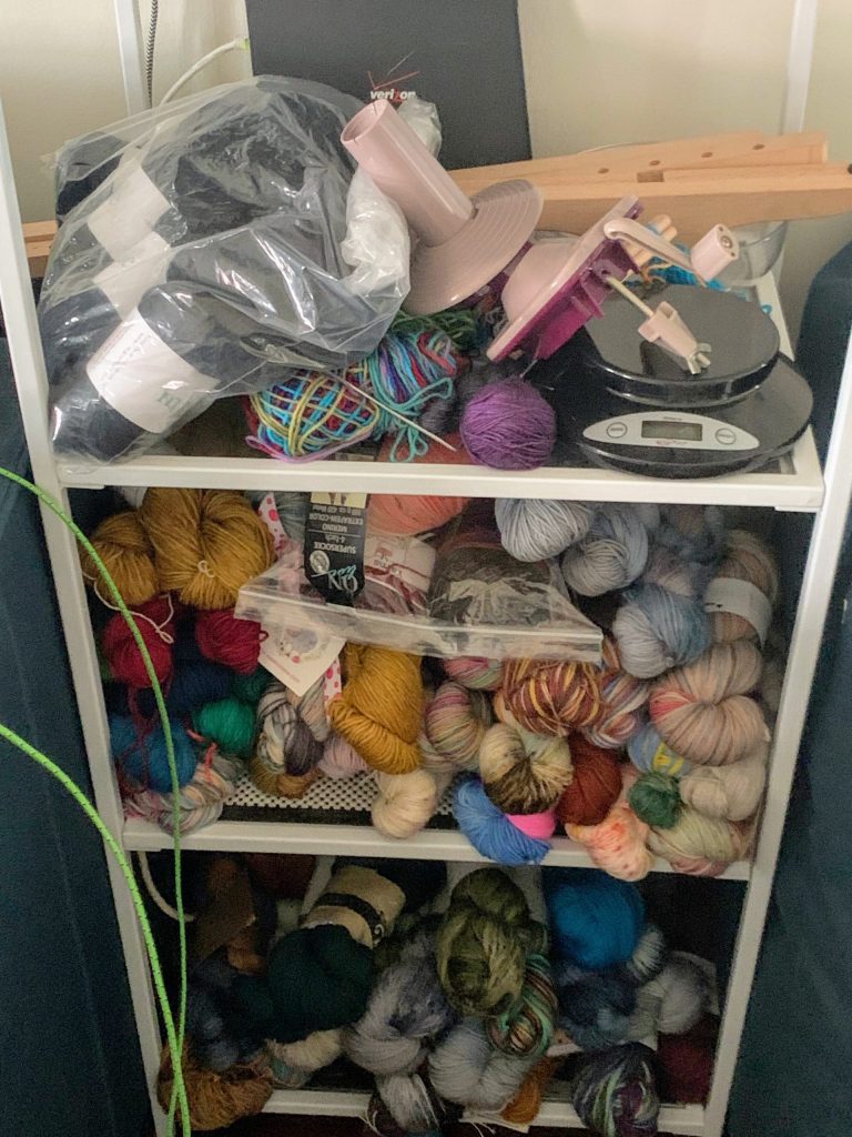 shelves covered in yarn piled high and messy