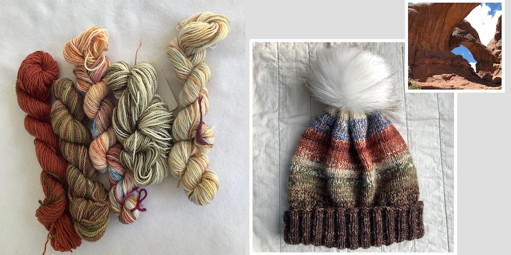 Skeins of yarn and a hat knit from them with a faux fur pompom