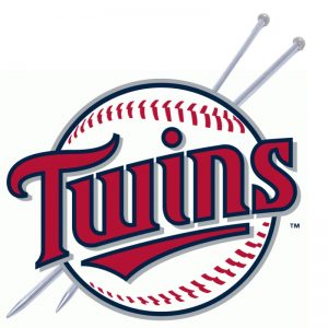 Twins logo in a baseball with knitting needles through it