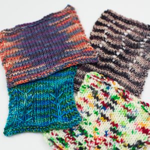 Swatched of hand knitting done in varagated yarns