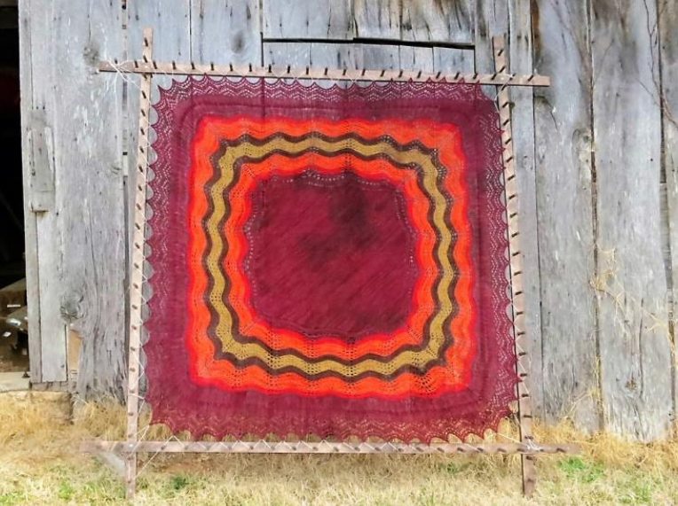 A hap shawl in reds and golds