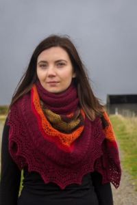 Woman wearing a hap shawl in shade of red