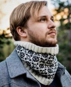 Man wearing a black and white hand knit cowl