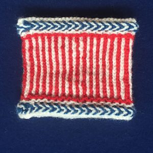 A twine knit cuff in red, white, and blue