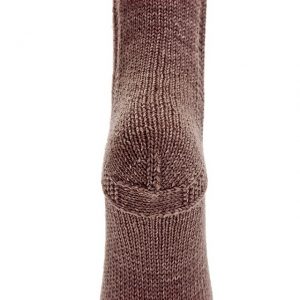 A brown, hand knit sock seen from the bottom of the heel.