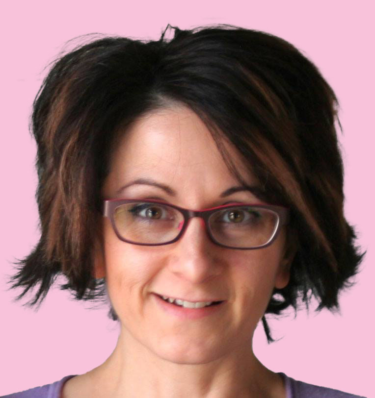 Headshot of a woman with chin length brown hair and glasses.