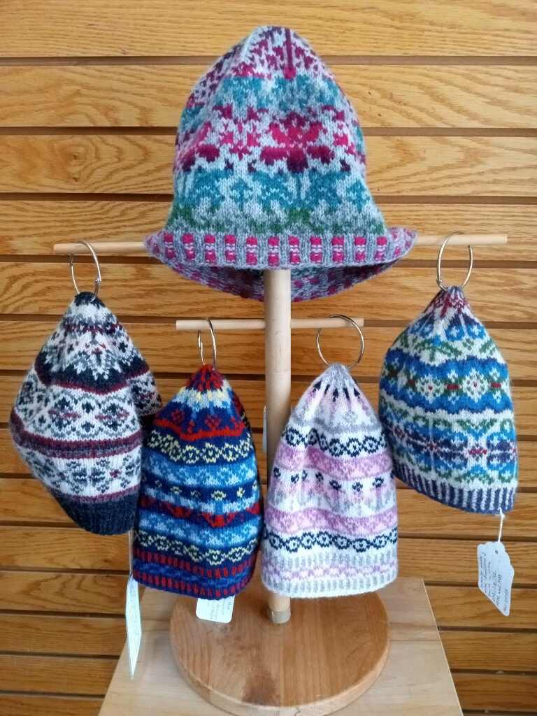 5 colorwork hats on a stand