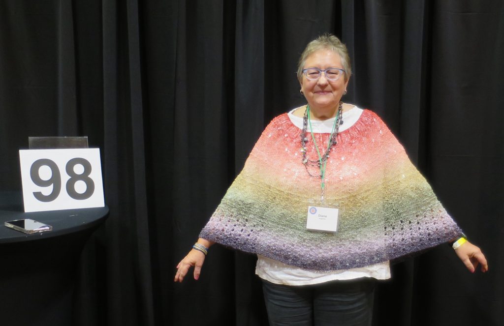 Woman modeling a hand knit shawl