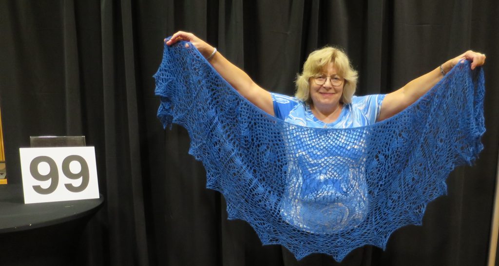 Woman showing blue lace shawl