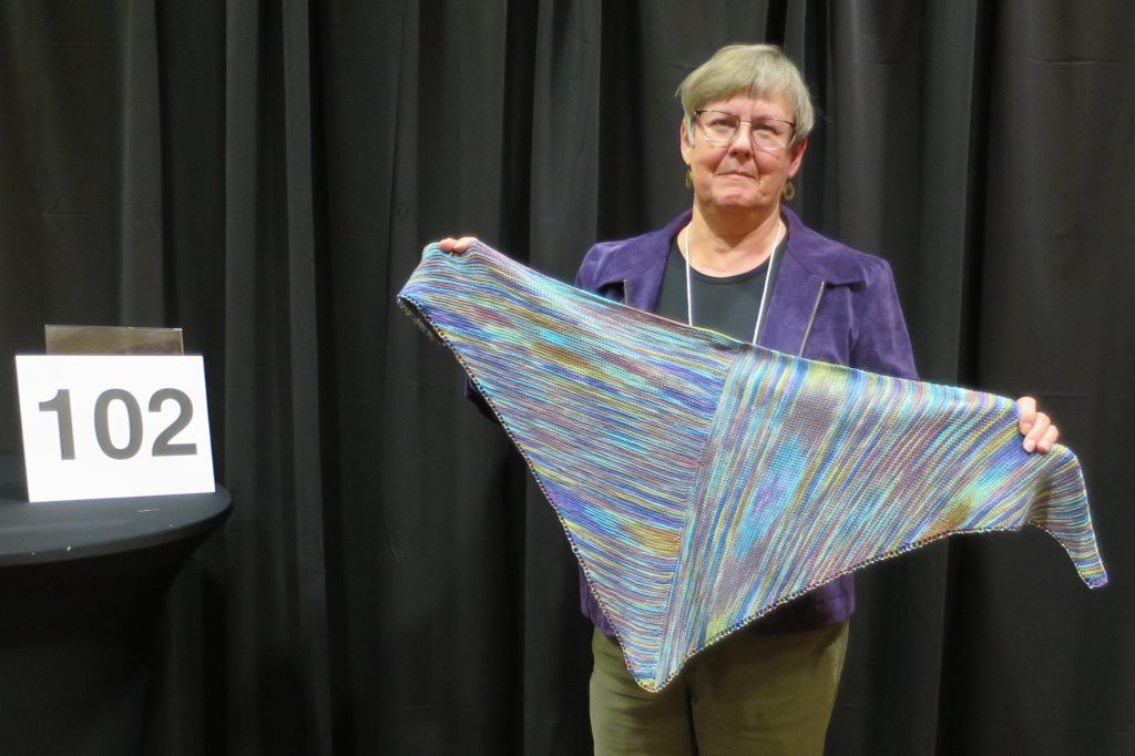 Woman showing multi-colored shawl
