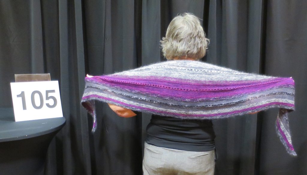 Woman modeling a grey and purple shawl