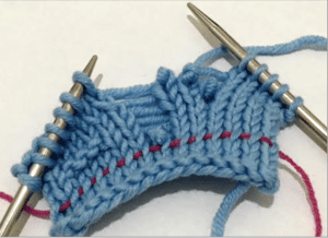 photo of knitting with a dropped stitch and lifeline